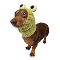 Load image into Gallery viewer, A dachshund wearing a knitted frog hood with large cartoon eyes and a cable-knit neck warmer, photographed on a clean white background.