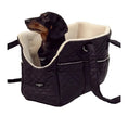 Load image into Gallery viewer, A black quilted dog carrier bag with a cream fleece interior, shown with a dachshund sitting inside. The bag has a small 'cocopup' brand label on the front pocket