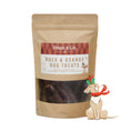 Load image into Gallery viewer, A stand-up kraft pouch of Hugo & Co. Duck & Orange Dog Treats with a clear window showing dark treats inside, set against a bright orange holiday background with snowflake graphics and a small illustrated dog wearing a red scarf.