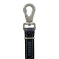 Load image into Gallery viewer, A close-up studio shot of a black woven strap with white stitching and a silver metal swivel clasp