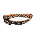 Load image into Gallery viewer, A fabric pet collar with a black and white jagged pattern, bright orange inner lining, and a black plastic buckle