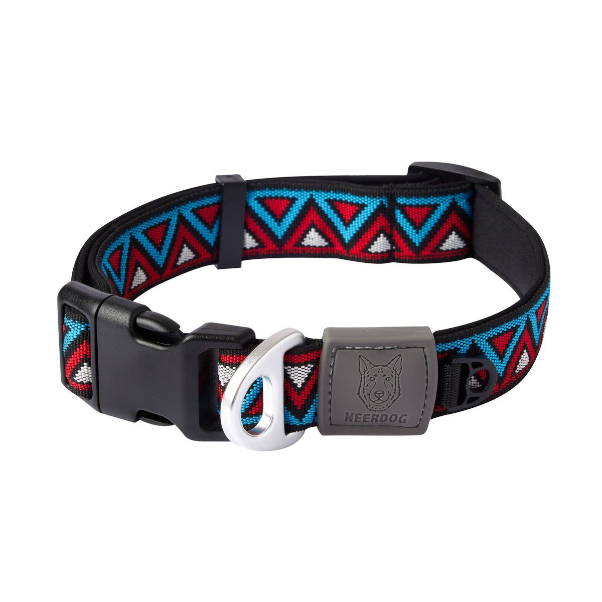 A dog collar with a black woven strap featuring a red, blue, and white geometric pattern, a black plastic buckle, and a gray metal ID tag engraved with a dog head and the brand name 'NEEDDOG'.