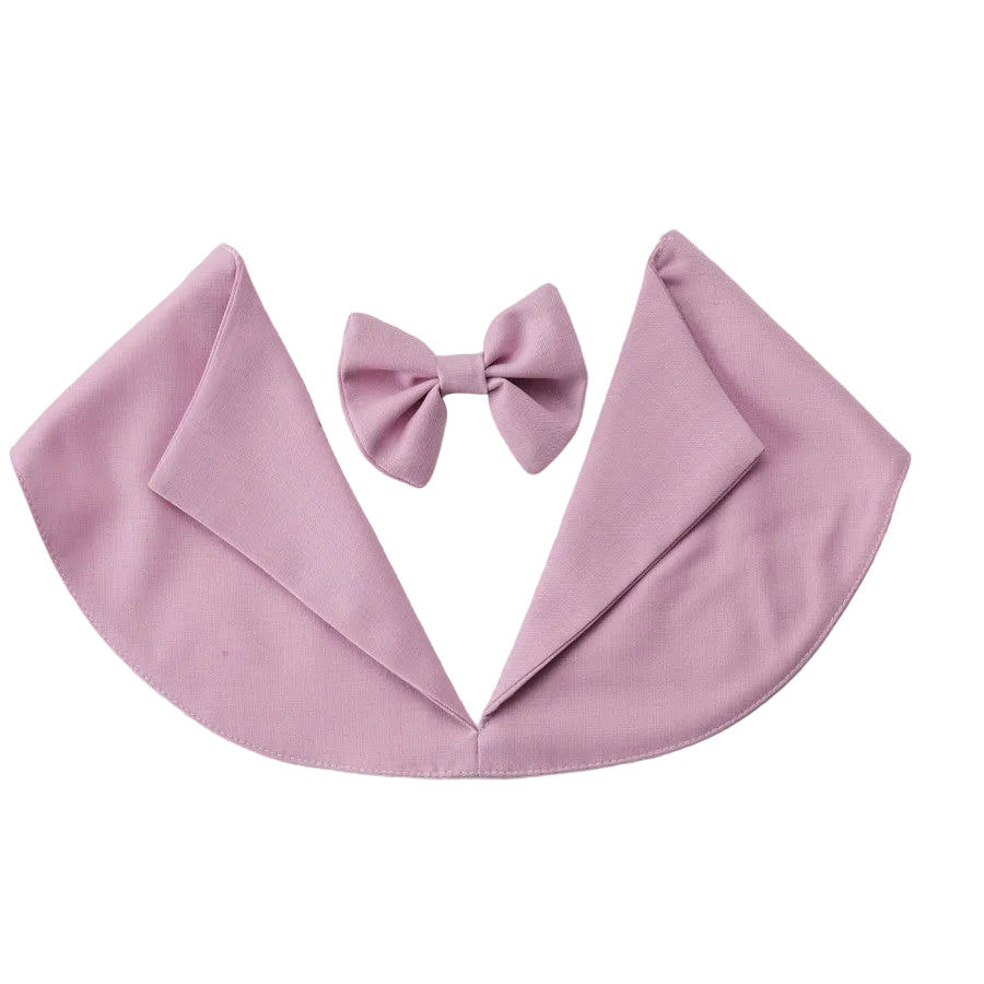 A pink baby cape with a matching bow tie, displayed flat on a light gray background.