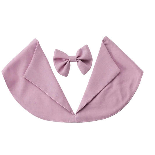 A pink baby cape with a matching bow tie, displayed flat on a light gray background.