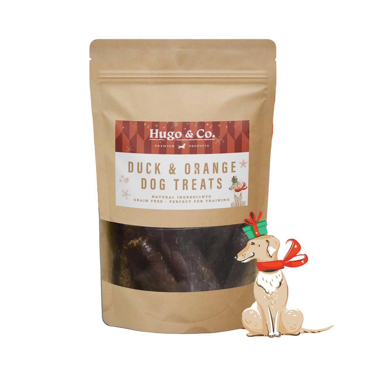 A stand-up kraft pouch of Hugo & Co. Duck & Orange Dog Treats with a clear window showing dark treats inside, set against a bright orange holiday background with snowflake graphics and a small illustrated dog wearing a red scarf.