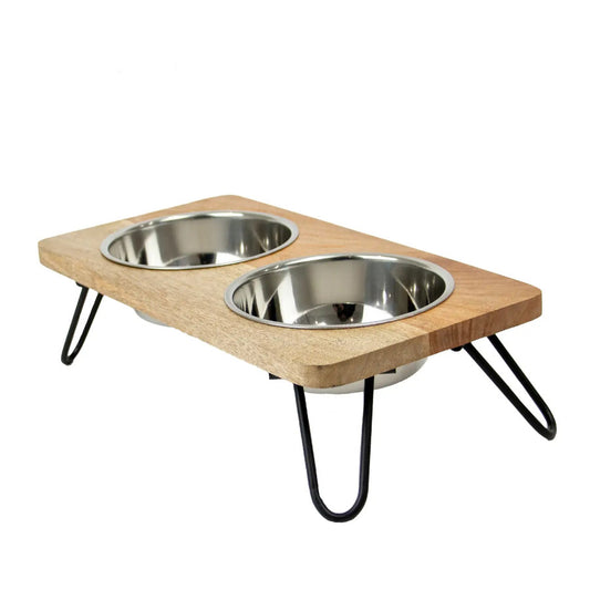 Wooden pet feeder with two metal bowls on a white background